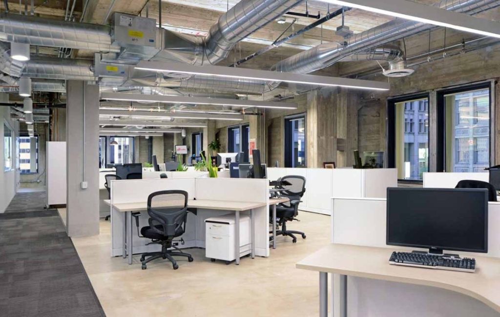 Open office with exposed spiral ductwork balanced for comfort